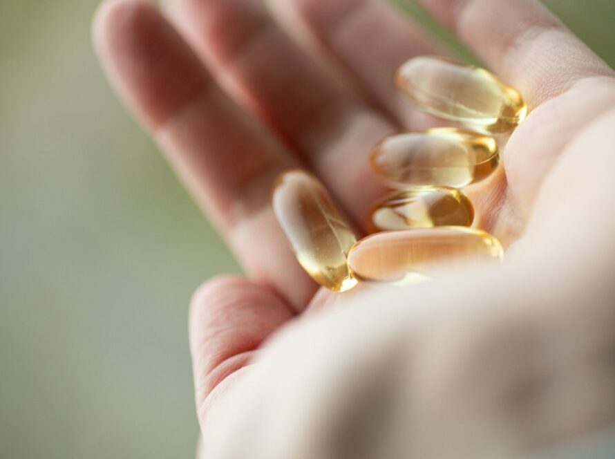 CoQ10 supplement capsules in hand